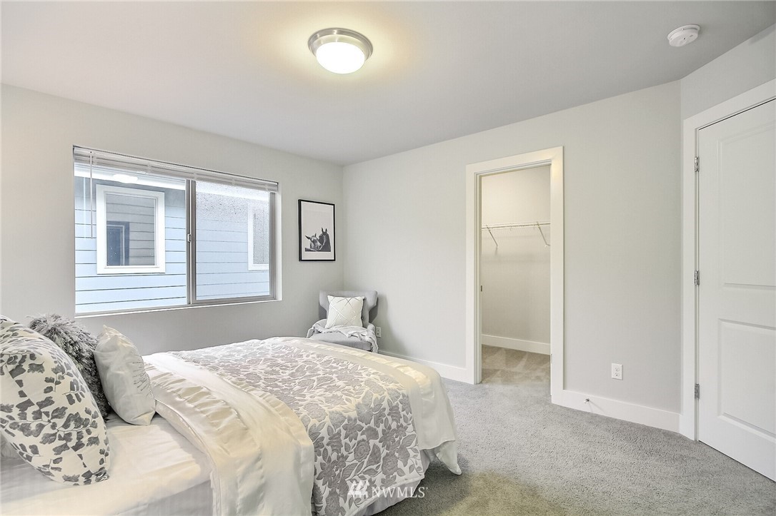 5113 Northeast 11th Place Renton, WA 98059 - Photo 29 of 40 a bedroom with a bed and a window
