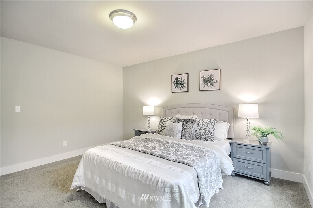 5113 Northeast 11th Place Renton, WA 98059 - Photo 30 of 40 a bedroom with a bed and a painting on the wall