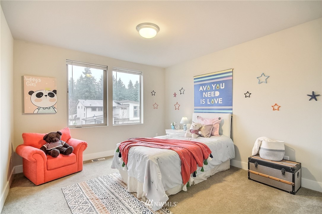 5113 Northeast 11th Place Renton, WA 98059 - Photo 31 of 40 a bedroom with a bed and a couch