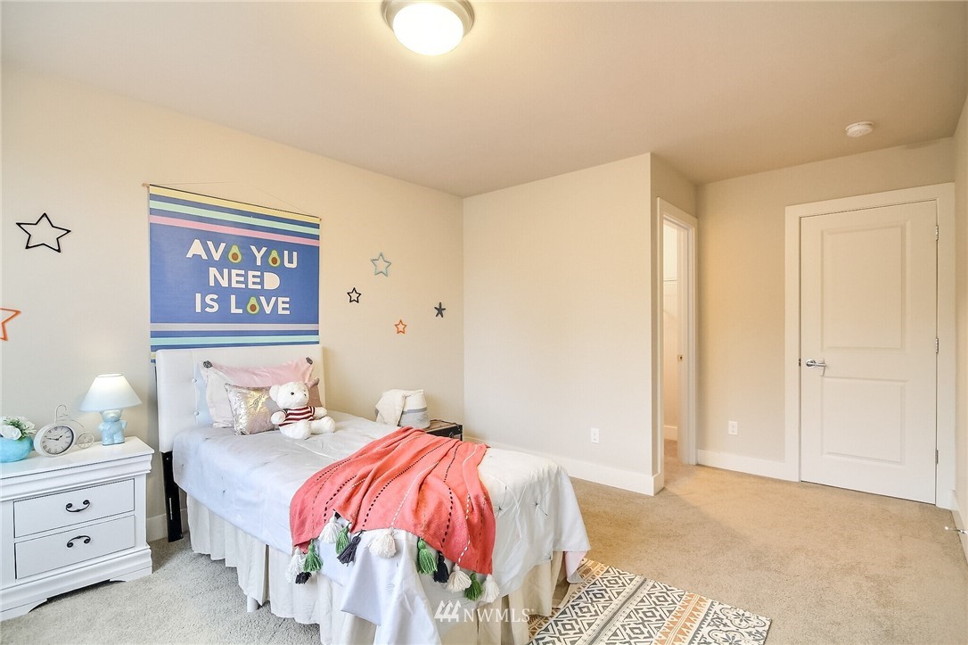 5113 Northeast 11th Place Renton, WA 98059 - Photo 32 of 40 a bedroom with a bed and a painting on the wall