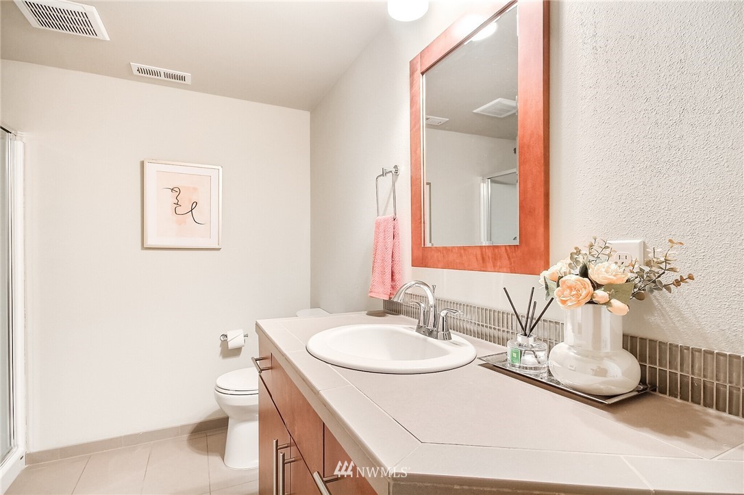 5113 Northeast 11th Place Renton, WA 98059 - Photo 33 of 40 a bathroom with a sink a toilet and mirror