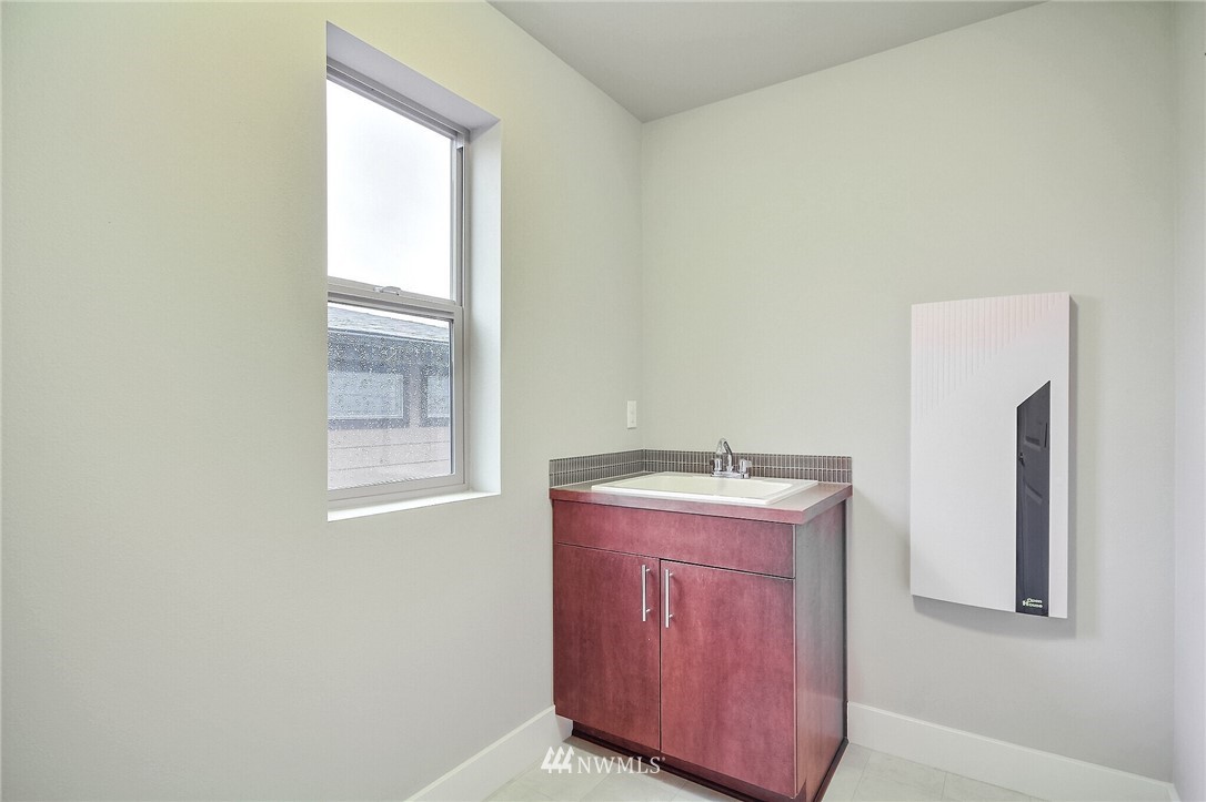 5113 Northeast 11th Place Renton, WA 98059 - Photo 35 of 40 a utility room with a sink a washer and dryer
