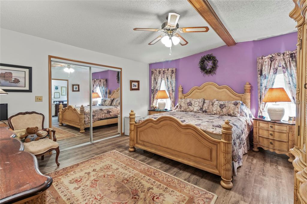 83 Eagle Circle Ellenton, FL 34222 - Photo 25 of 60 a bedroom with a bed and wooden floor