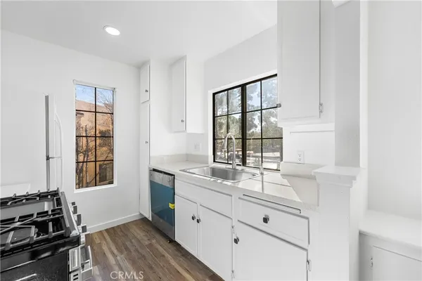 a kitchen with a sink stove and cabinets