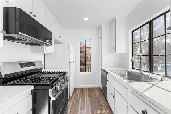 a kitchen that has a sink and a stove