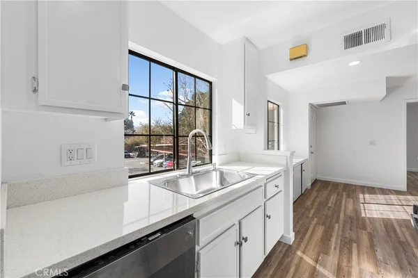 a kitchen with a sink and cabinets