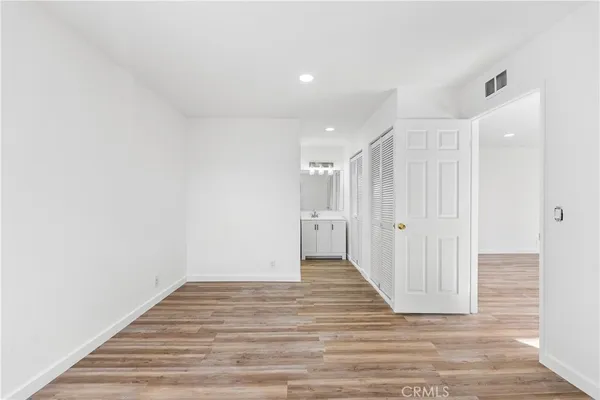a view of a hallway with wooden floor