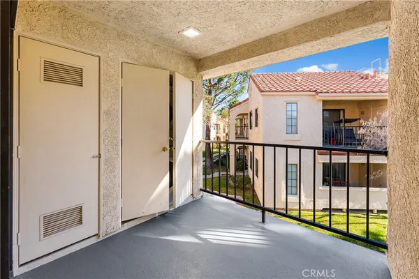 a view of a porch with a floor to ceiling window