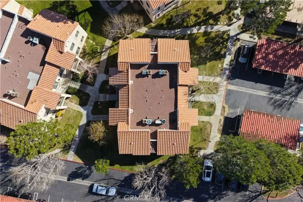 an aerial view of a house with a yard