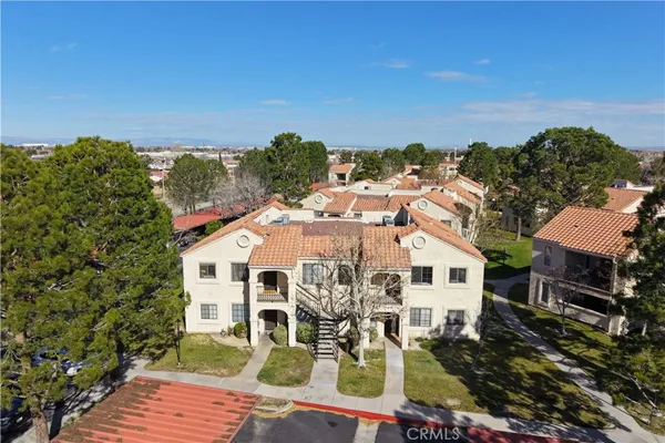 a view of a white house with wooden floor and city view