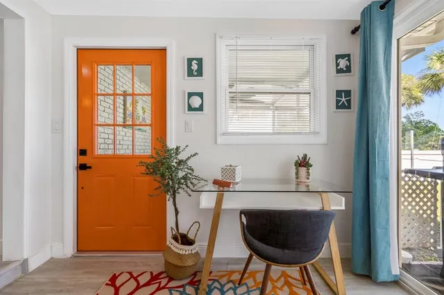 a room with a chair and a potted plant