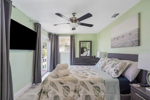 a bedroom with a bed and a chandelier