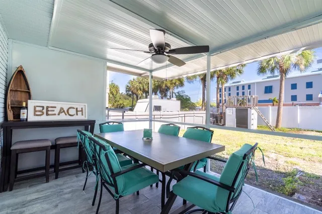 a view of a dining table and chairs in a patio