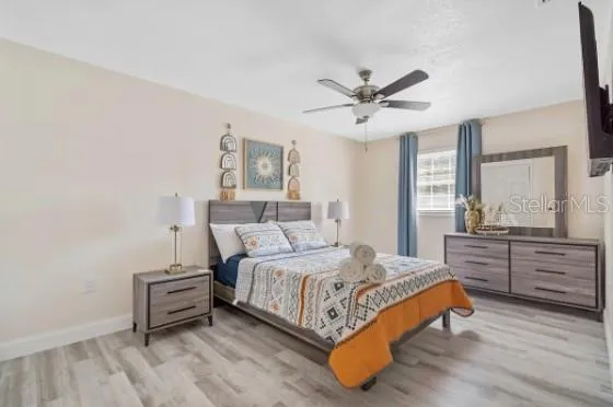 a bedroom with a bed and wooden floor