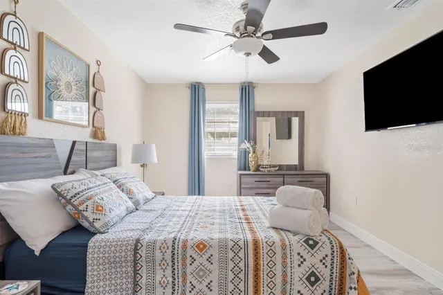 a bedroom with a large bed and a flat screen tv