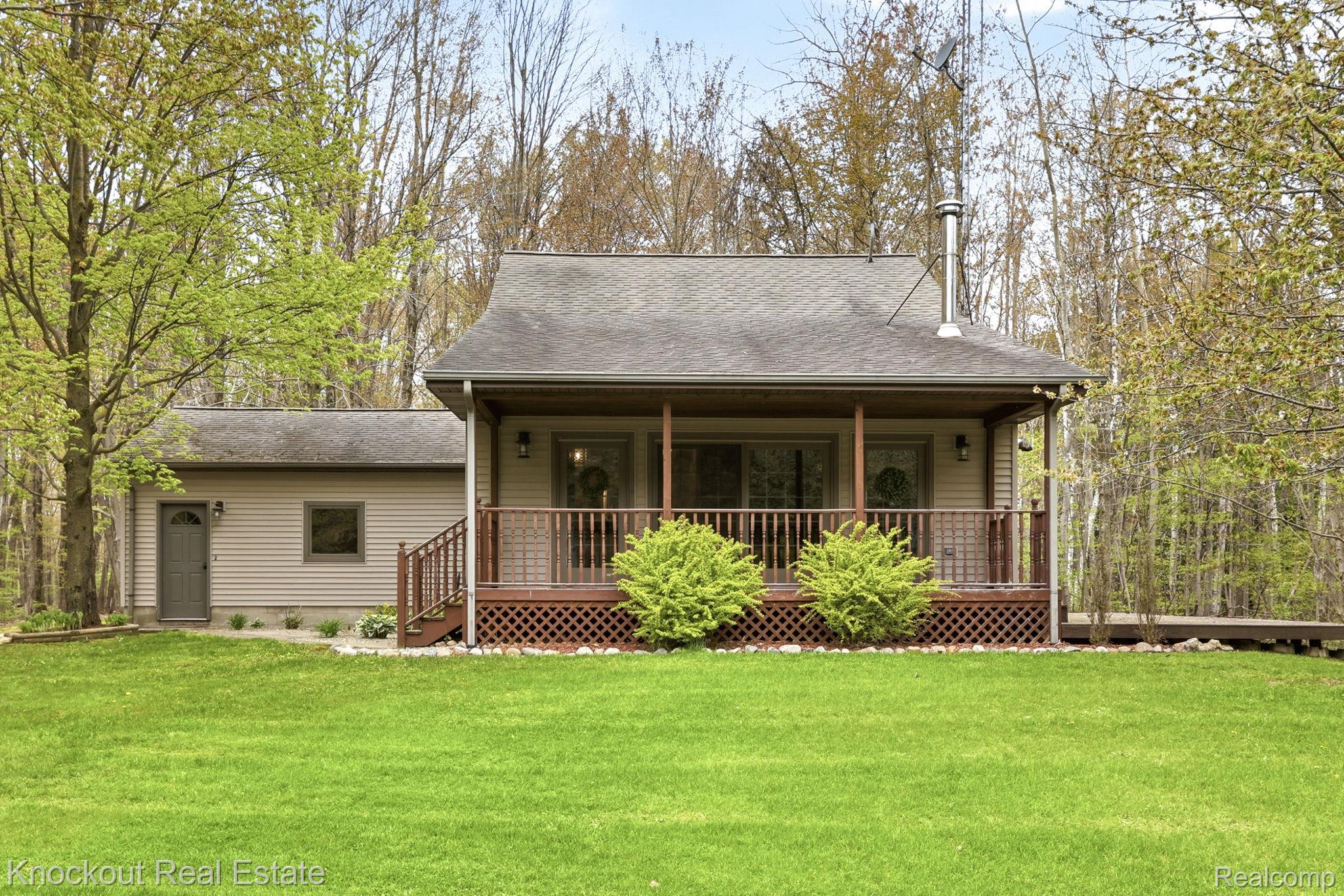 1608 South Pinnebog Road Bad Axe, MI 48413 - Photo 2 of 54 View of front facade featuring a front yard, roof with shingles, and a porch
