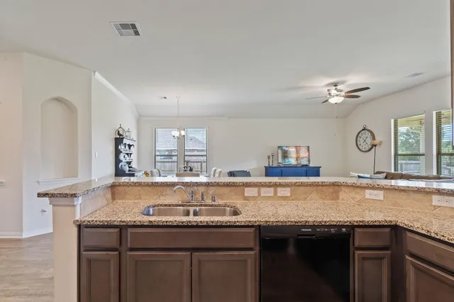a kitchen with stainless steel appliances granite countertop a sink stove and microwave