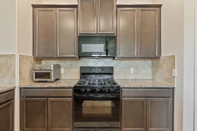 a kitchen with a sink and a stove