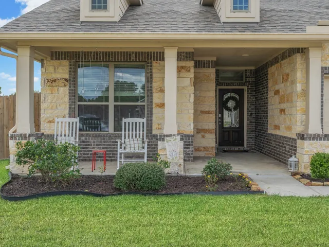 a view of front door of house with a yard