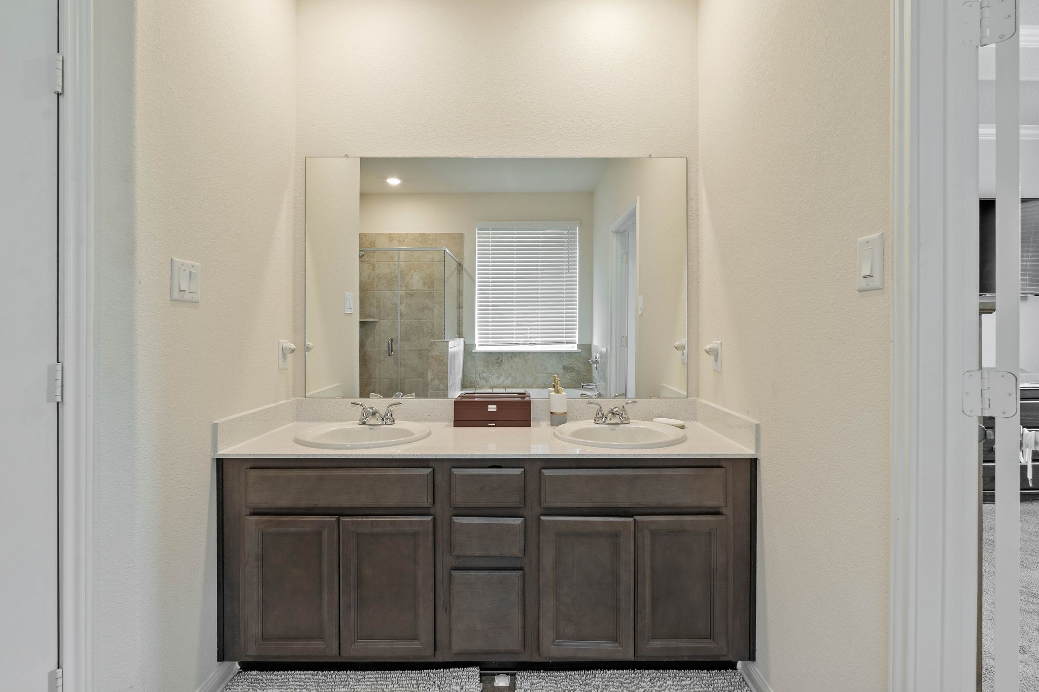 16450 Stonewall Street Conroe, TX 77303 - Photo 22 of 43 Vanity area in the primary bath with mirror and storage cabinetry.