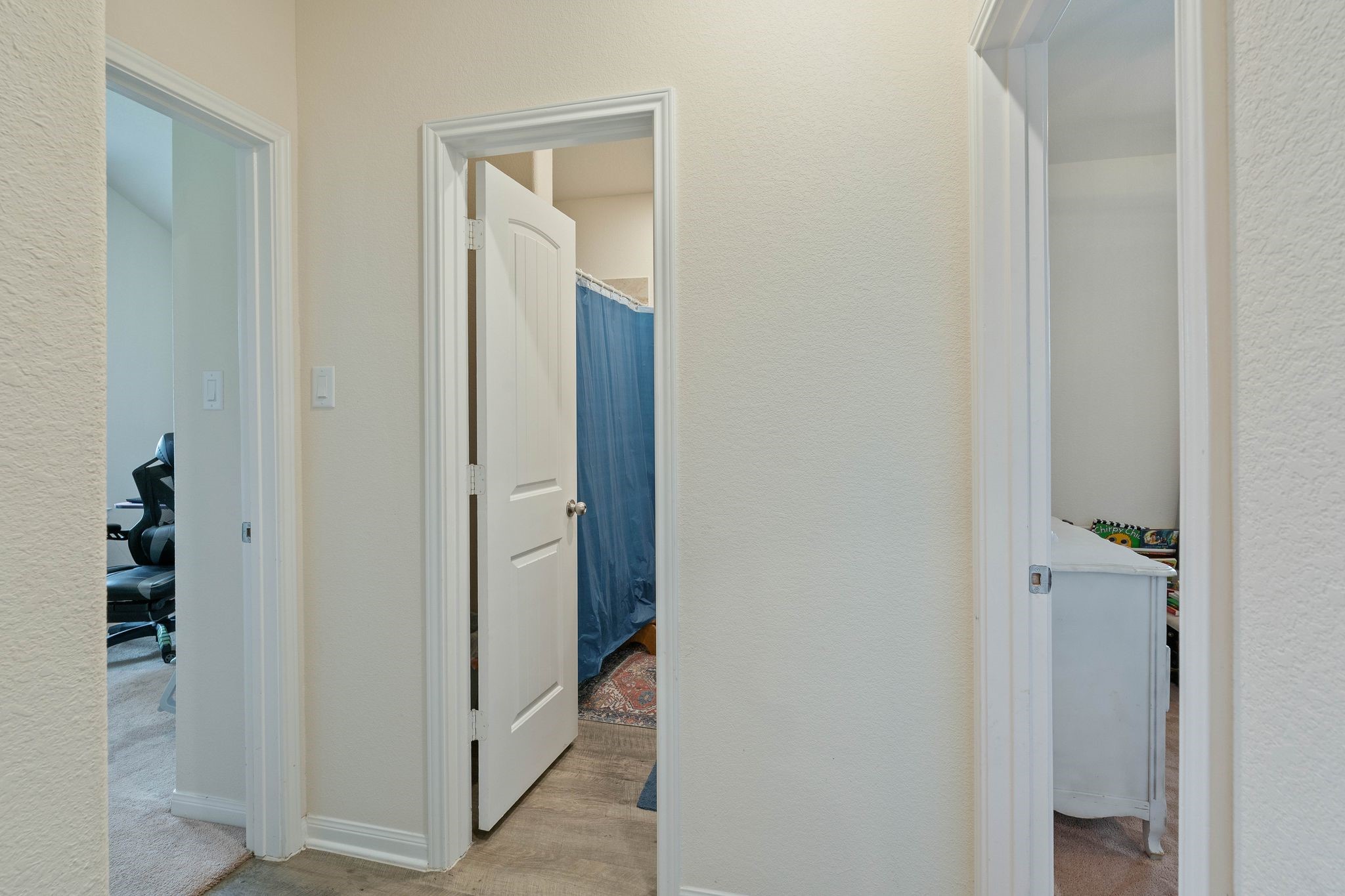 16450 Stonewall Street Conroe, TX 77303 - Photo 27 of 43 Hallway view connecting bedroom, bathroom, and home office with clean, neutral finishes.