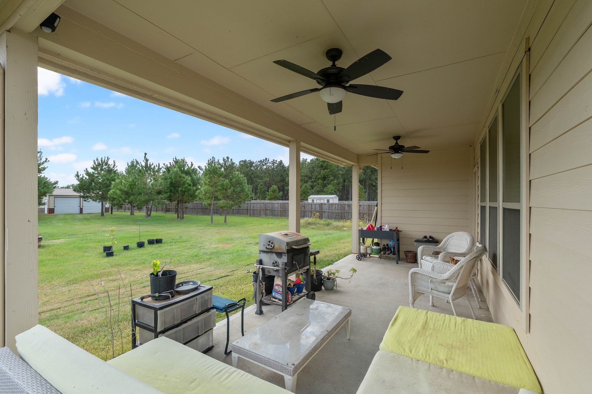 16450 Stonewall Street Conroe, TX 77303 - Photo 31 of 43 Covered back patio with ceiling fan and open view to backyard.