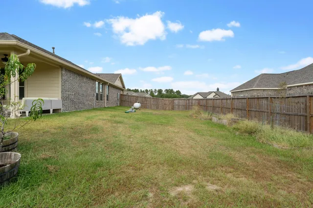 a front view of a house with a garden and yard