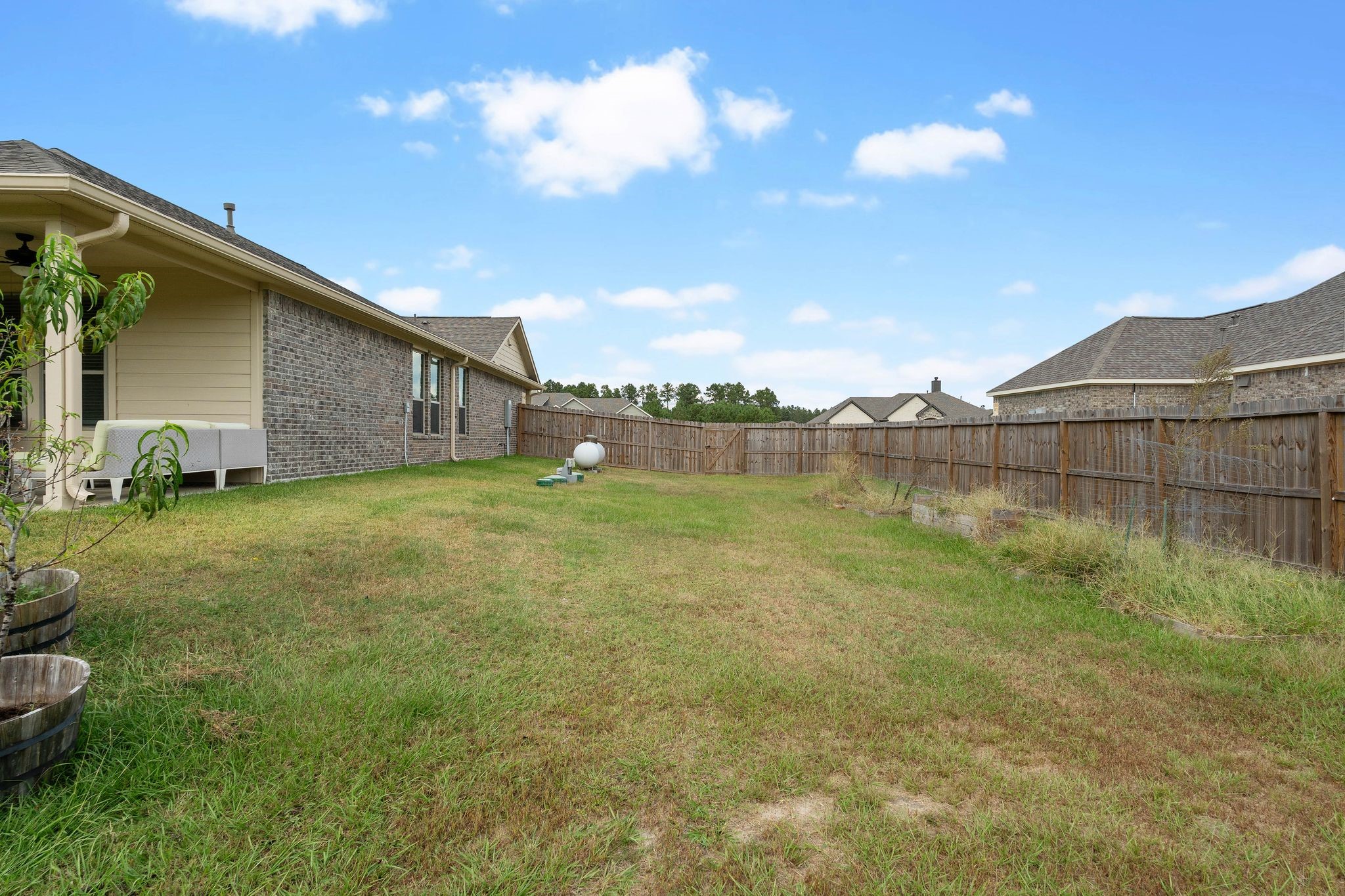 16450 Stonewall Street Conroe, TX 77303 - Photo 33 of 43 Side view of home and fenced backyard.