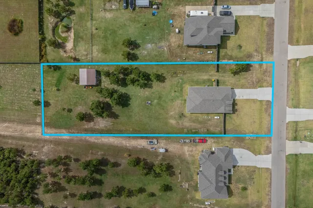 an aerial view of residential houses with outdoor space