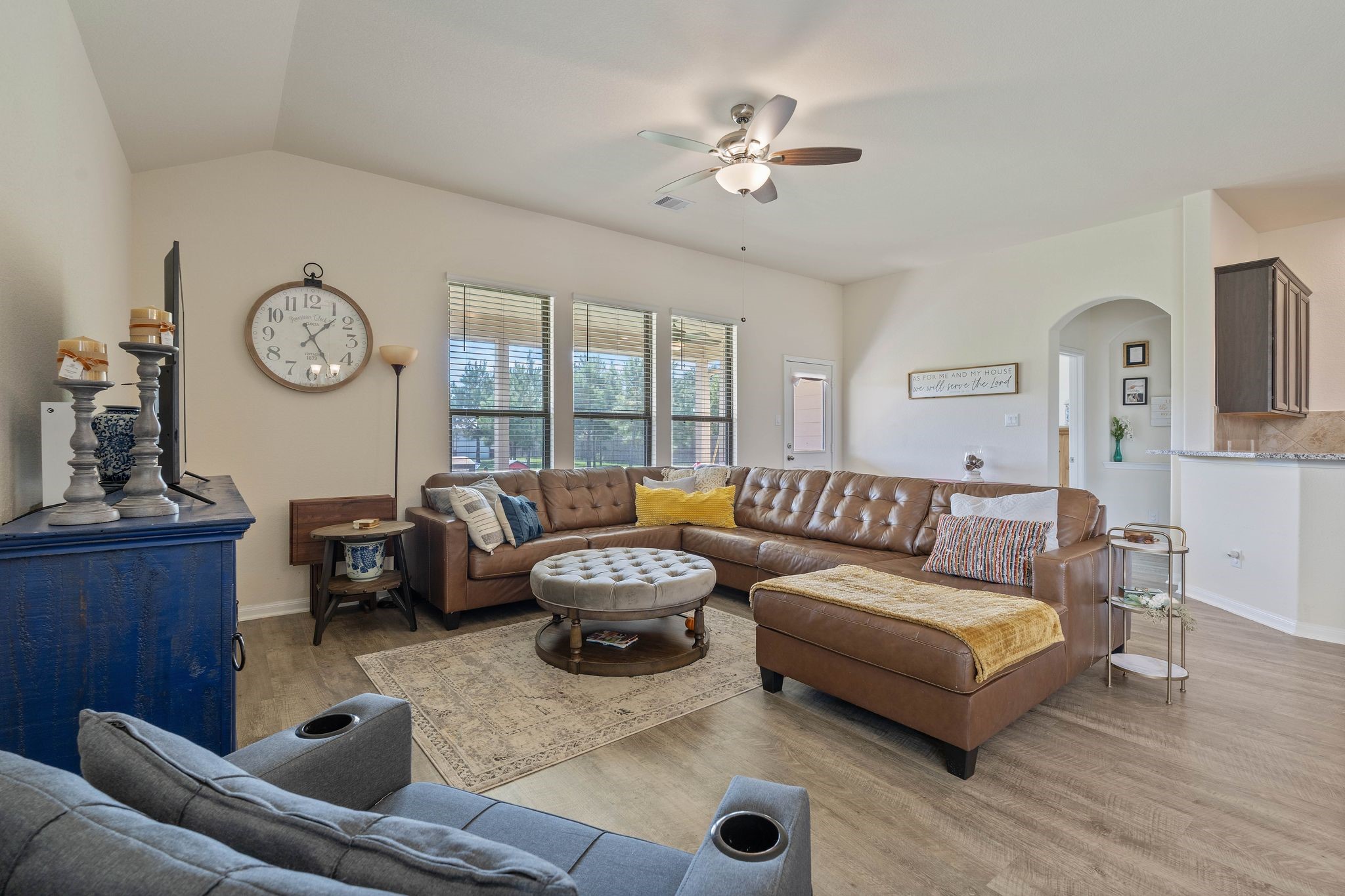 16450 Stonewall Street Conroe, TX 77303 - Photo 4 of 43 Spacious living room with ceiling fan, large windows, and open flow into dining area.