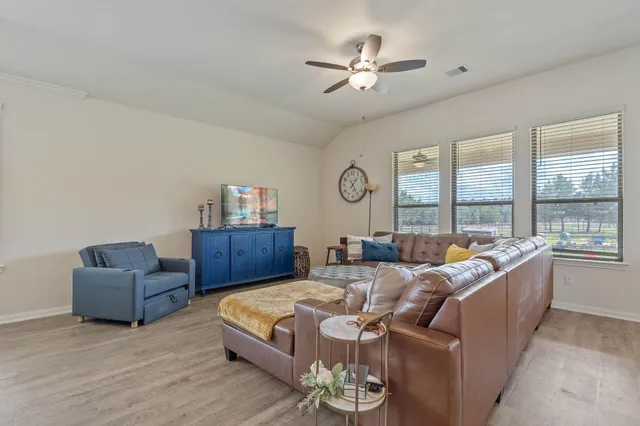 a bedroom with furniture and a large window