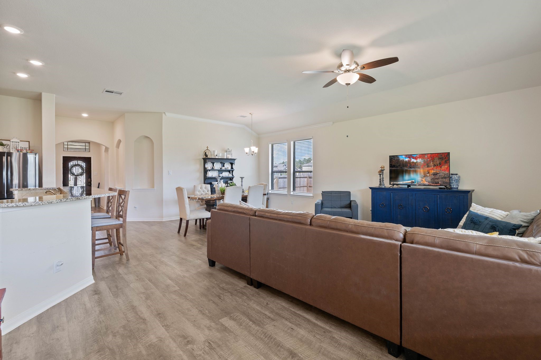 16450 Stonewall Street Conroe, TX 77303 - Photo 43 of 43 Open-concept floor plan connecting living room, dining area, and kitchen.