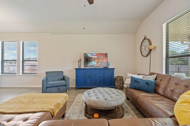 a living room with furniture and kitchen view