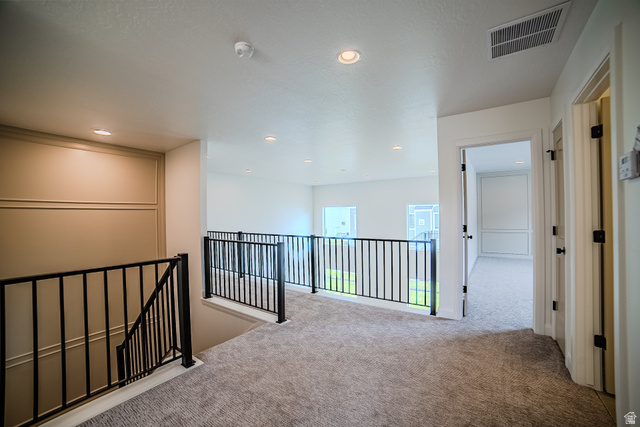 223 South Cottonwood Road, Unit 7501 Vineyard, UT 84059 - Photo 24 of 45 Upper-level landing featuring a carpeted floor, recessed lighting, and black metal railings