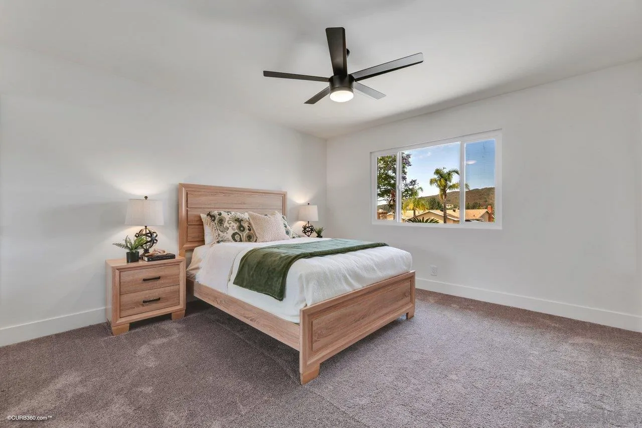 13331 Tobiasson Road Poway, CA 92064 - Photo 14 of 24 a spacious bedroom with a bed and painting on the wall