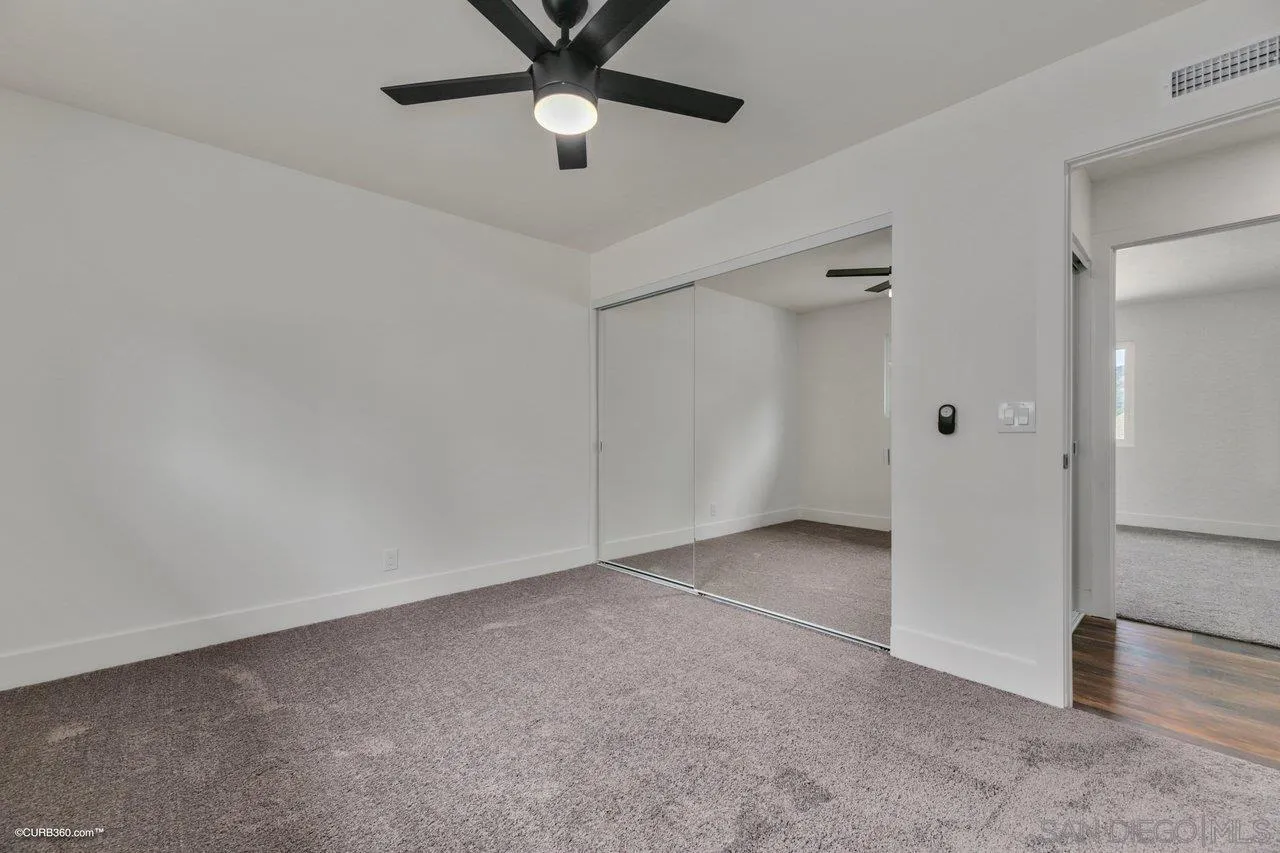 13331 Tobiasson Road Poway, CA 92064 - Photo 15 of 24 an empty room with closet and windows