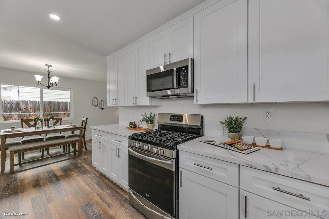 13331 Tobiasson Road Poway, CA 92064 - Photo 7 of 24 a kitchen with stainless steel appliances white cabinets granite counter tops and a stove