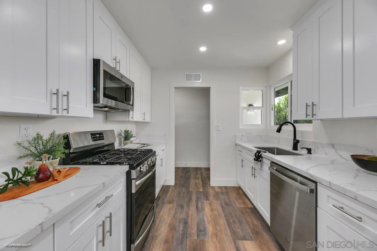 13331 Tobiasson Road Poway, CA 92064 - Photo 8 of 24 a kitchen with stainless steel appliances granite countertop a stove a sink and a microwave