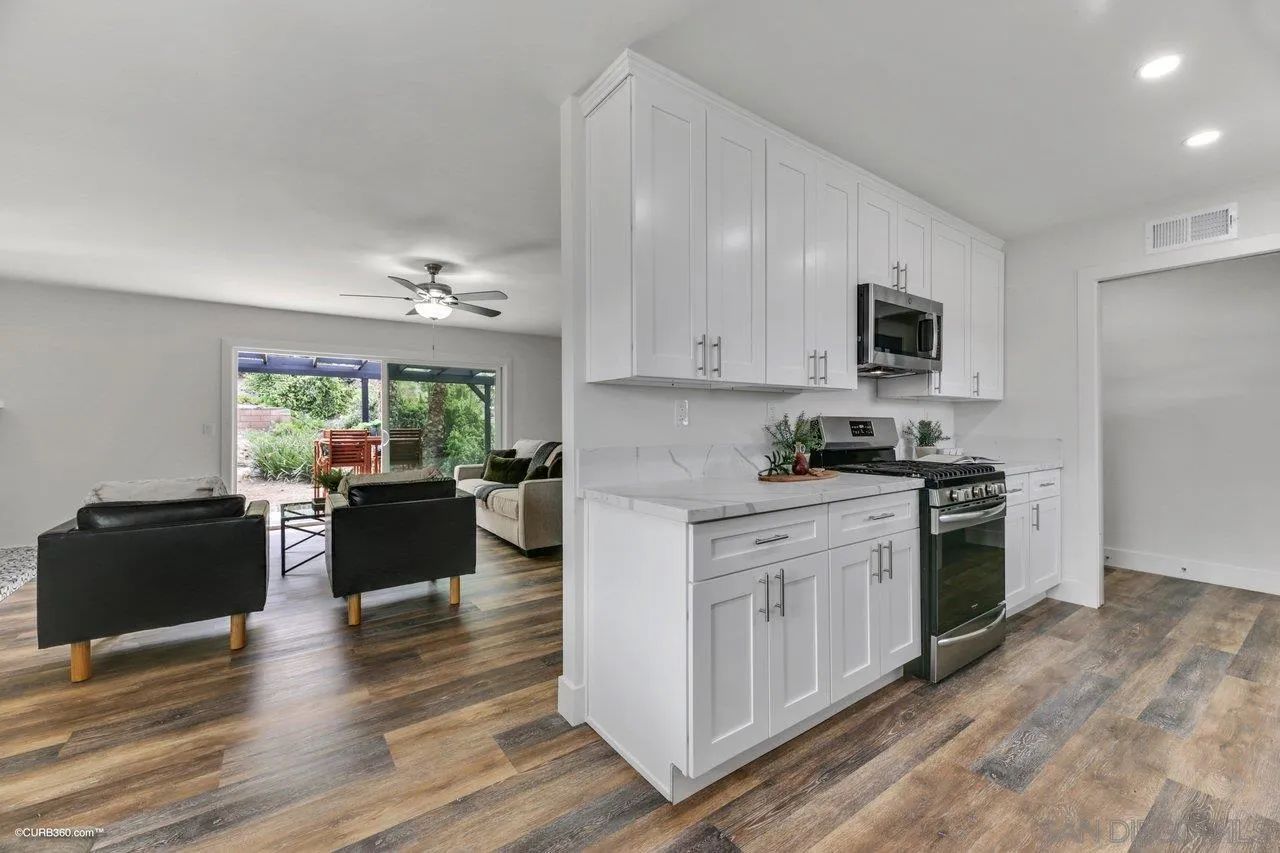 13331 Tobiasson Road Poway, CA 92064 - Photo 9 of 24 a kitchen with kitchen island granite countertop lots of counter top space and stainless steel appliances