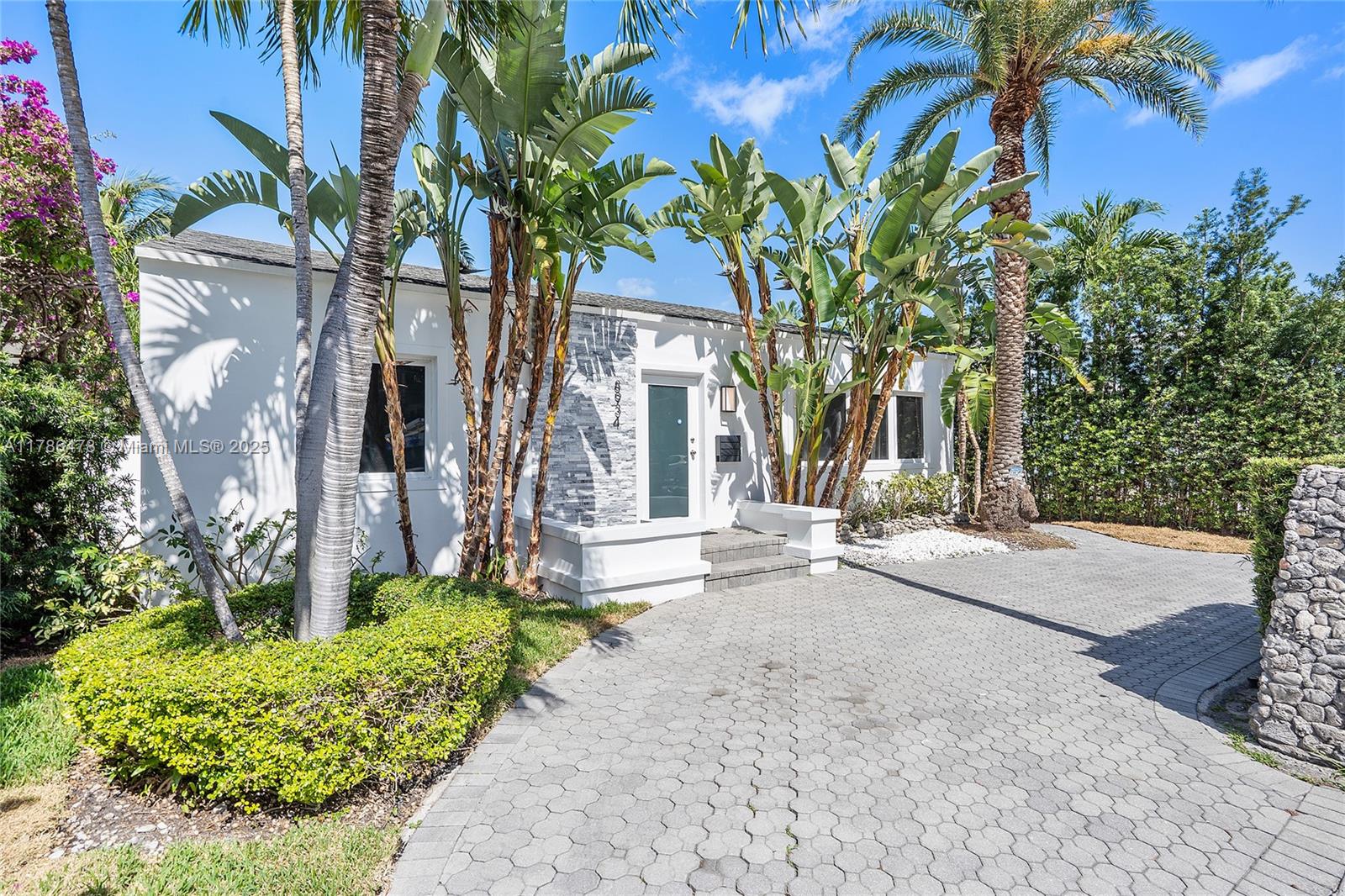 front view of a house with a tree