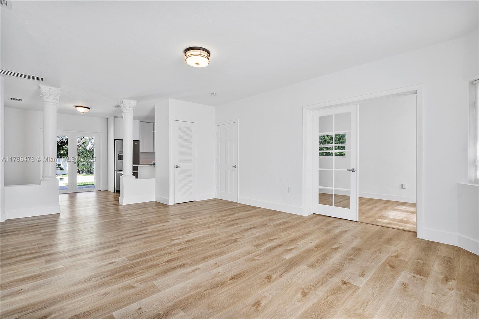 8934 Harding Avenue Surfside, FL 33154 - Photo 12 of 52 a view of empty room with wooden floor
