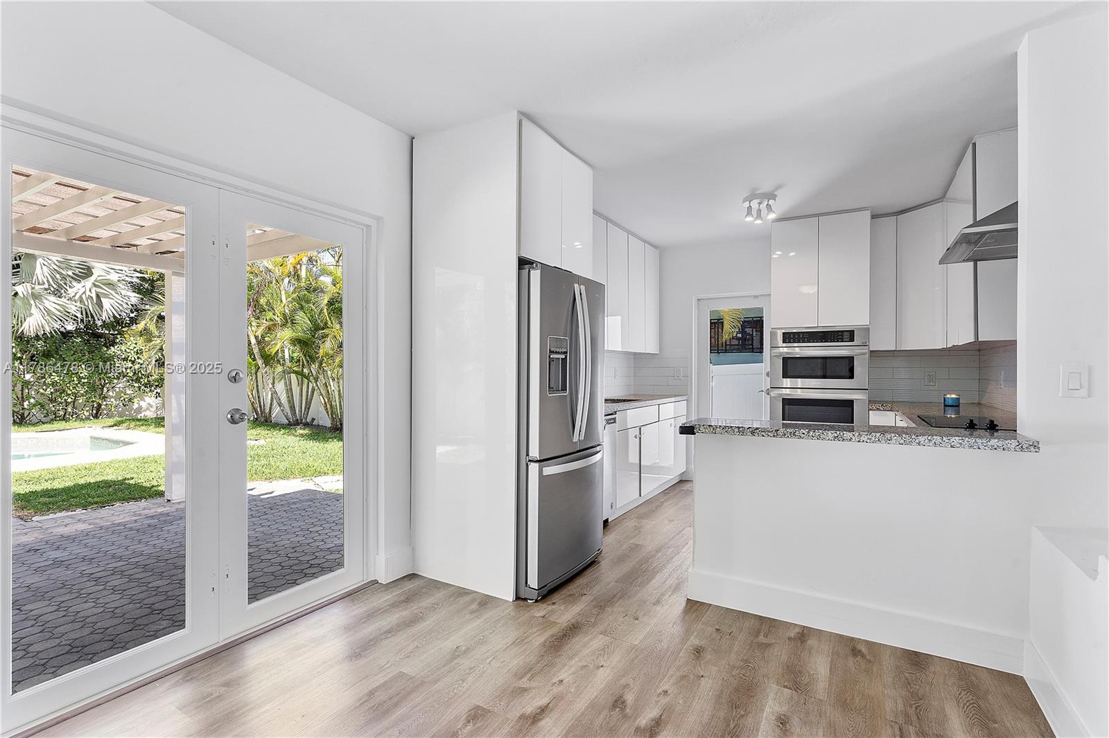 8934 Harding Avenue Surfside, FL 33154 - Photo 18 of 52 a kitchen with stainless steel appliances a refrigerator and a stove top oven