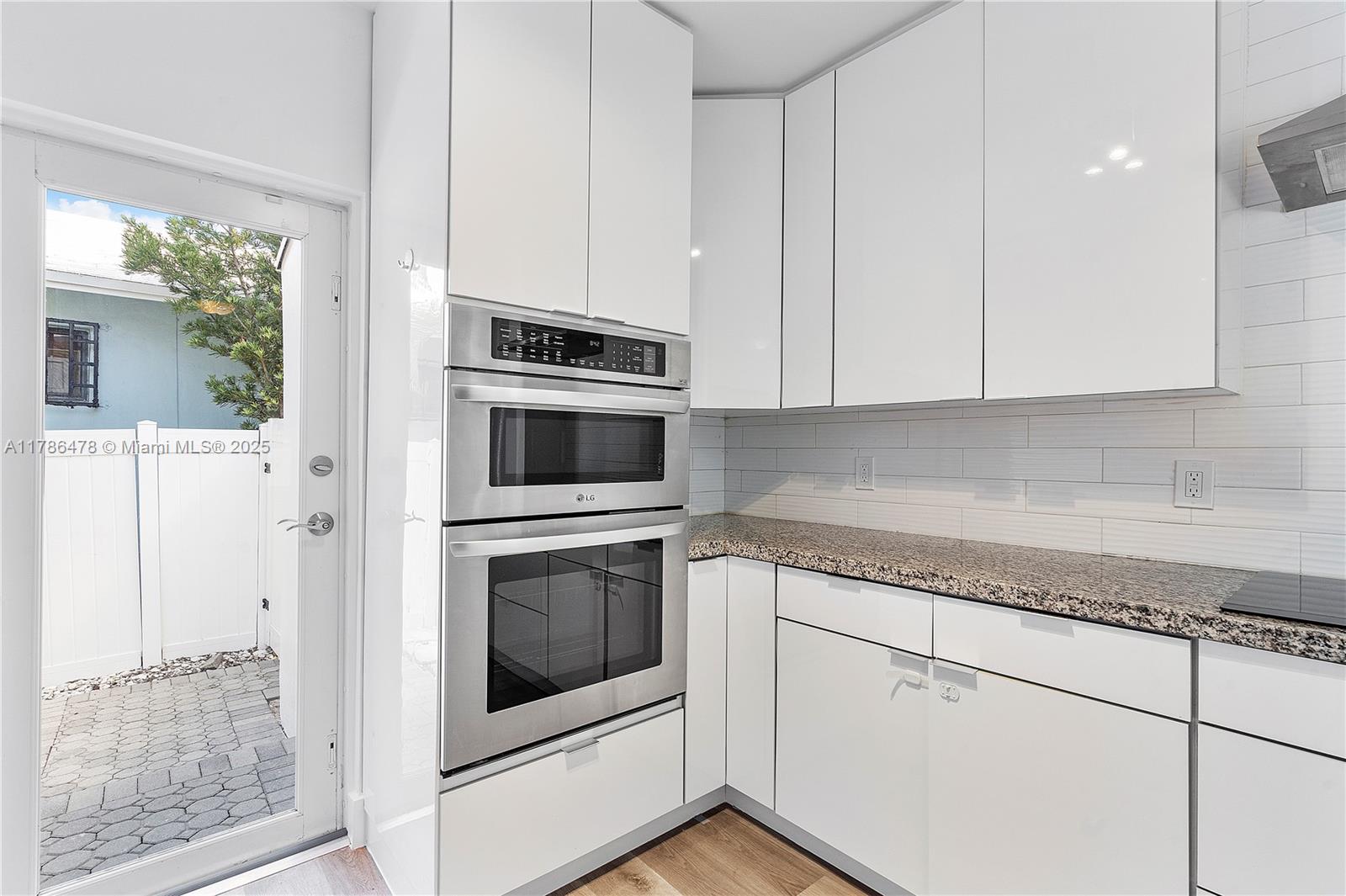 8934 Harding Avenue Surfside, FL 33154 - Photo 22 of 52 a kitchen with granite countertop cabinets stainless steel appliances and a counter space