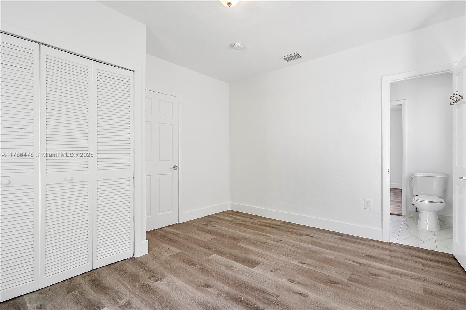 8934 Harding Avenue Surfside, FL 33154 - Photo 33 of 52 a view of an empty room with wooden floor and a sink