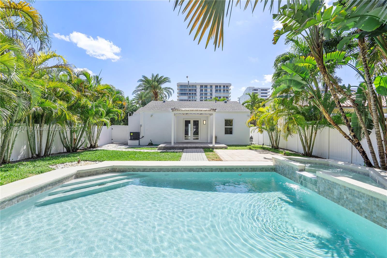 8934 Harding Avenue Surfside, FL 33154 - Photo 40 of 52 a view of a house with a yard and palm trees