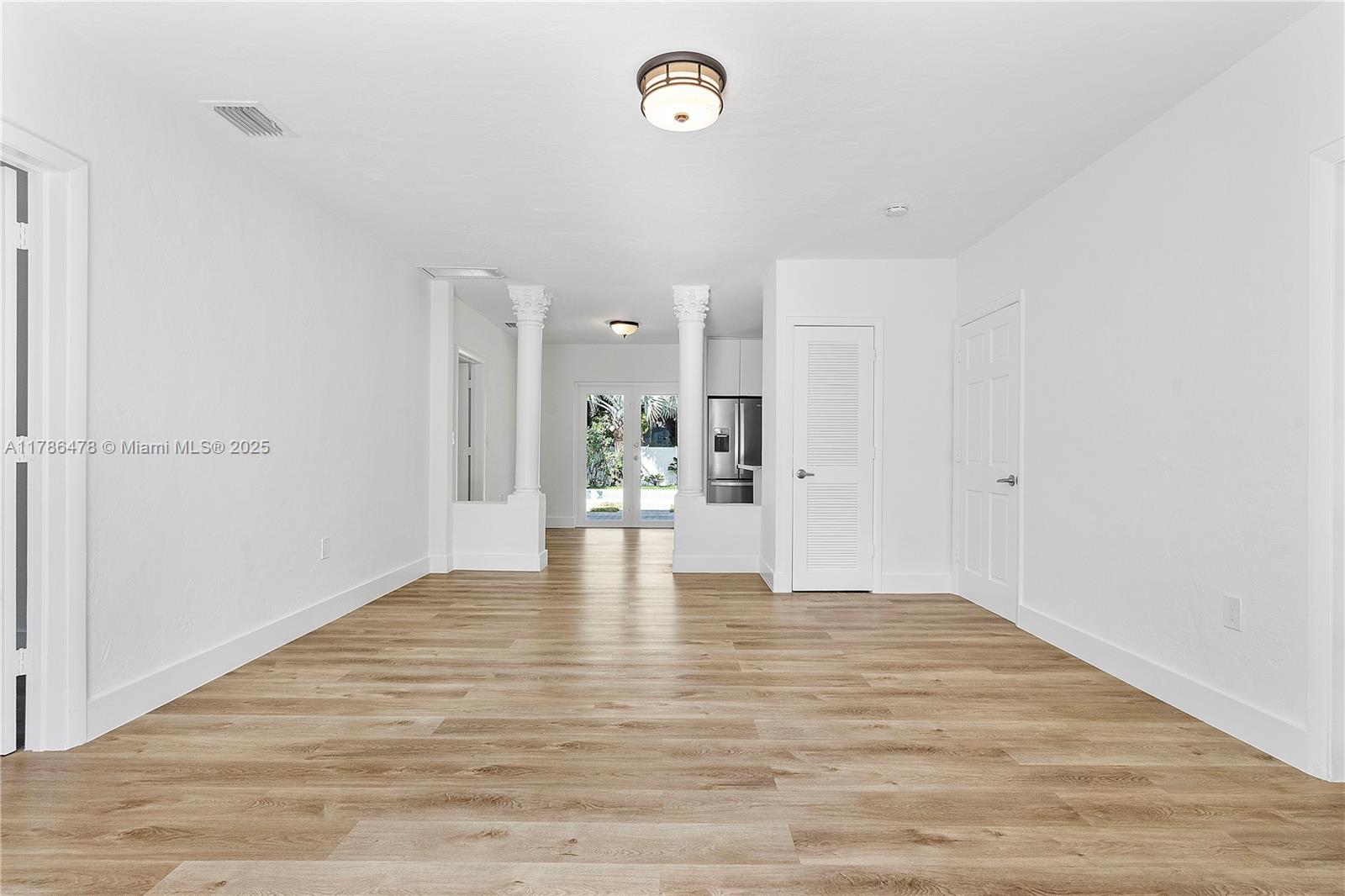 8934 Harding Avenue Surfside, FL 33154 - Photo 10 of 52 a view of empty room with wooden floor