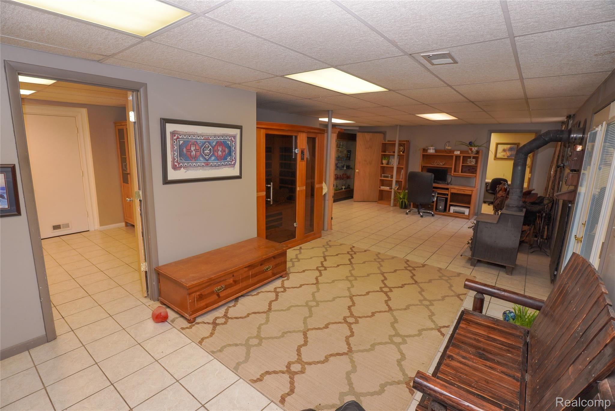 6996 Crofoot Road Fowlerville, MI 48836 - Photo 20 of 36 Finished Basement! ceramic Tile flooring & Wood Burning Stove!