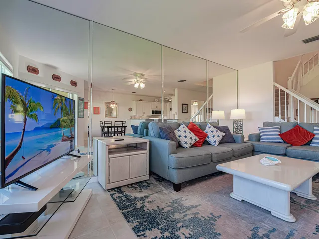 a view of a patio with table and chairs a barbeque with wooden fence and floor