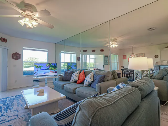 a kitchen with kitchen island granite countertop a sink cabinets and stainless steel appliances