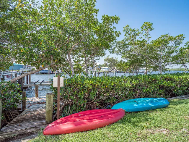 a view of a patio with table and chairs under an umbrella